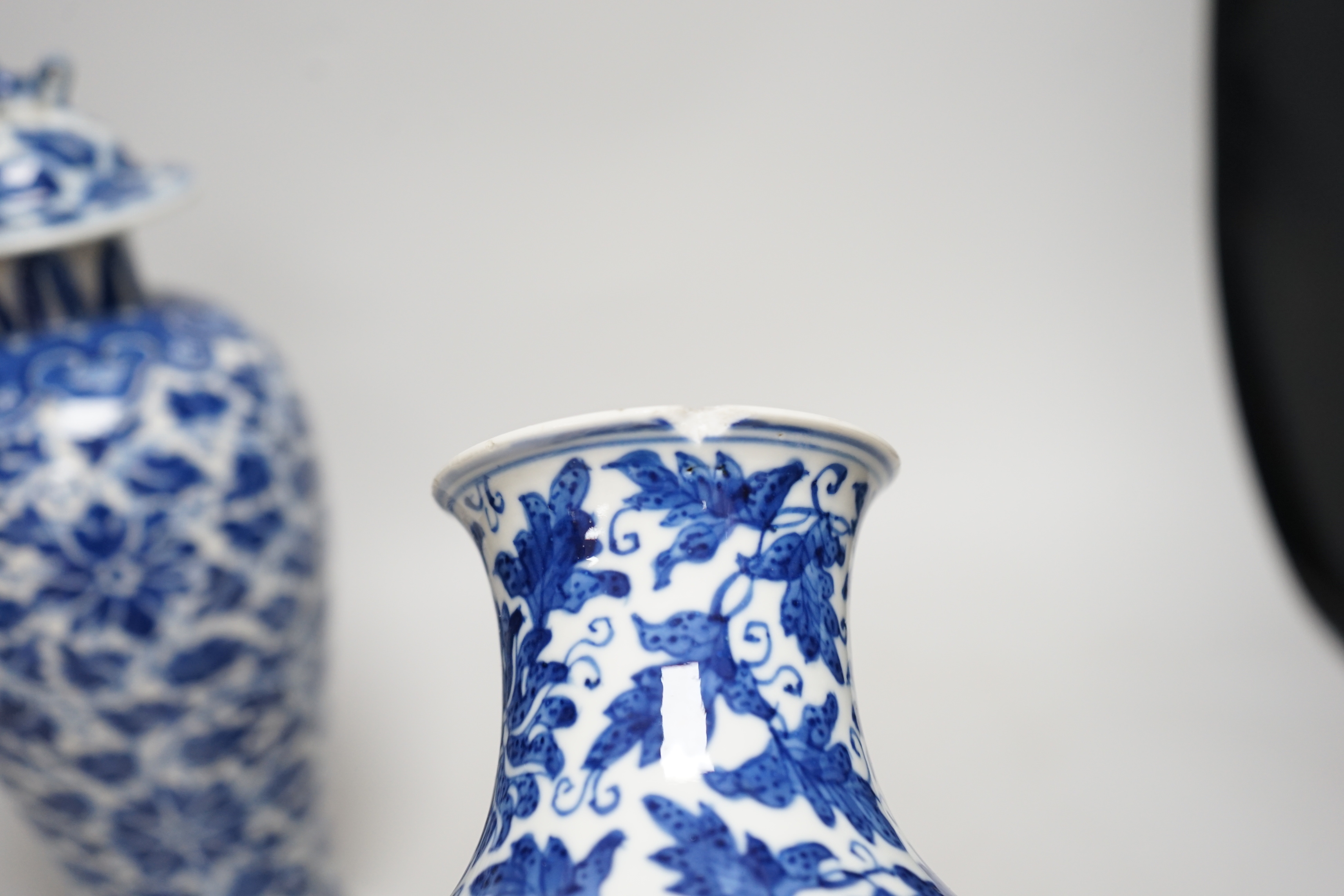 A late 19th century Chinese blue and white 'Lotus' vase and cover and another similar (2), tallest 31cm